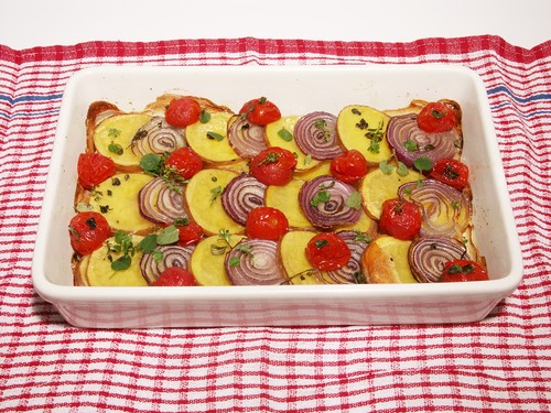 Scalloped Red Jackets potatoes with red onion & cherry tomatoes
