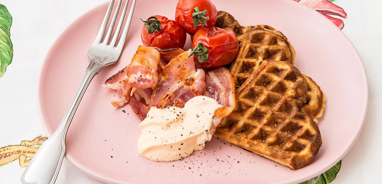 Potato and Parmesan waffles with tomatoes, bacon and spicy mayo
