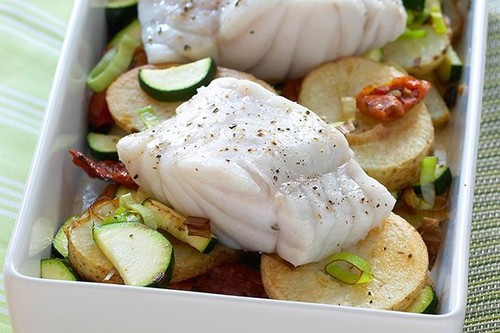 Baked fish on potatoes