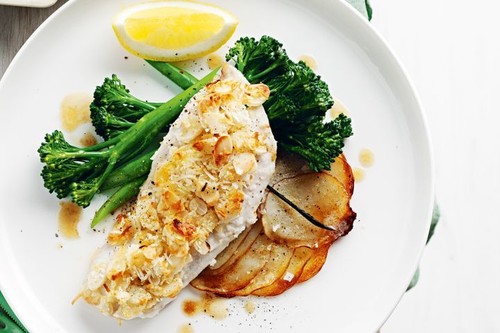 Almond and coconut crusted fish on potato galettes with vanilla butter