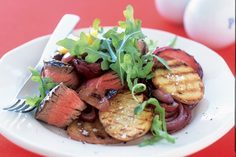 Barbecued steak with potato and red onion