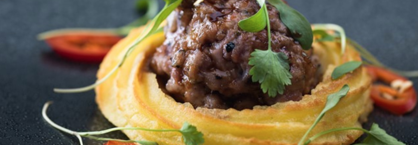 Wasabi Duchess Potato with Honey and Soy Glazed Sausage