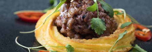 Wasabi Duchess Potato with Honey and Soy Glazed Sausage